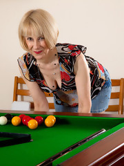 Natural Hazel bends over the pool table